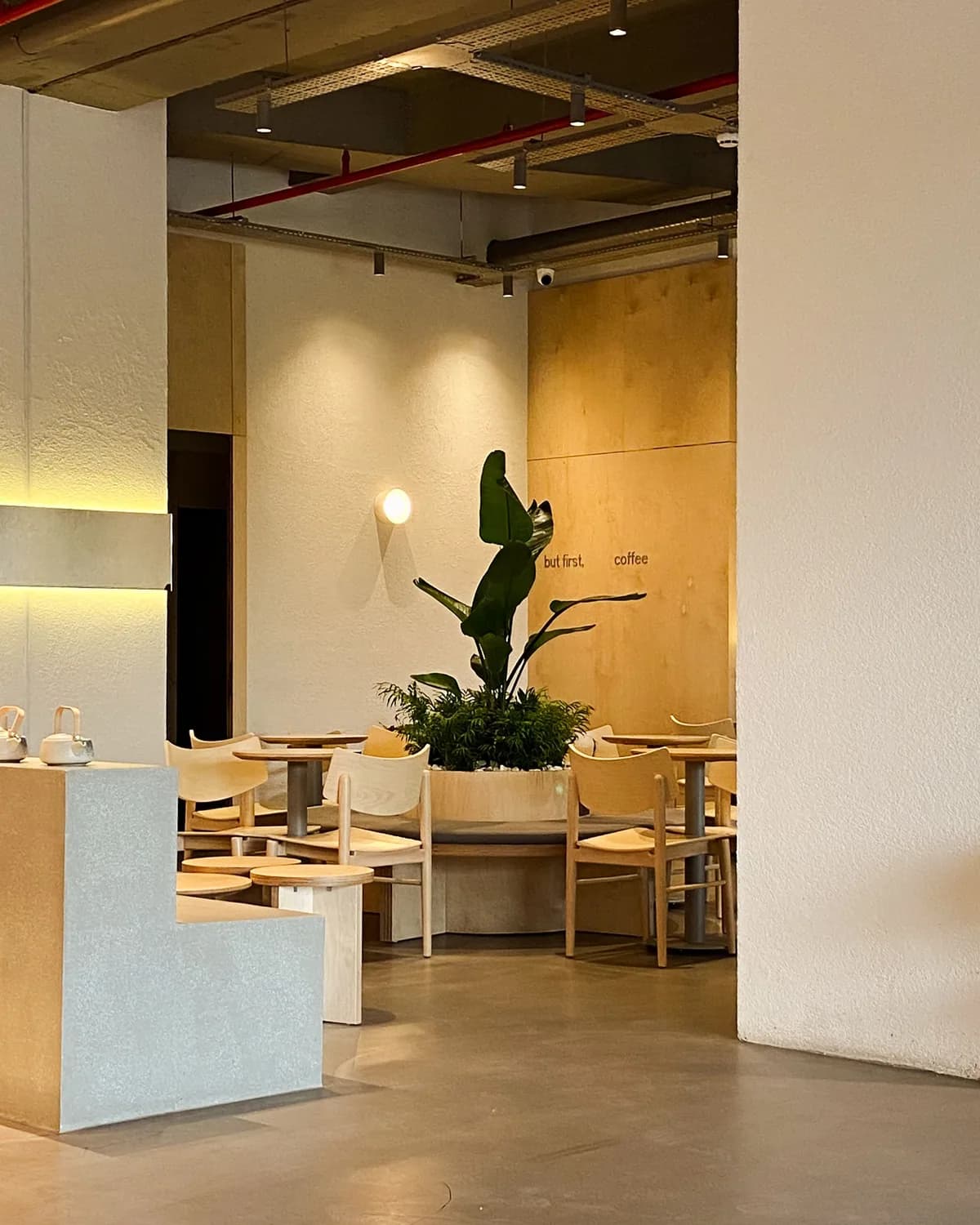 Modern cafe interior with tables and banquette seating